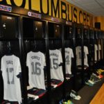Columbus football team locker room shot of lockers with hanging jerseys