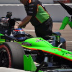 Danica Patrick in race car with team preparing the vehicle