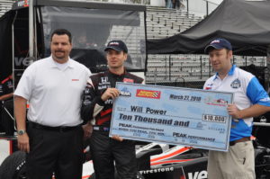 Tom Cavalli helping present a $10,000 check to Will Power.