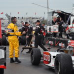 On the track with the pit crew and race car drivers