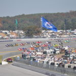 Action shot of race cars coming around the turn at Talladega