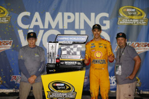 Tom Cavalli and friend posing for picture with NASCAR Sprint Cup winnerJoey Logano