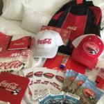 Coca Cola paraphernalia laid out on top of bed