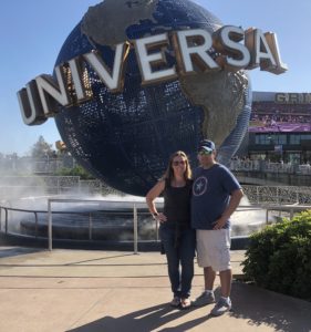 Tom and Leigh Cavalli standing in front of the Universal Studio World fountain