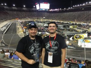 Tom Cavalli and friend standing in front of the race car track at the Bristol Nascar Race