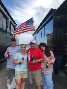 Tom and Leigh Cavalli posing with friends at the Coke Zero 400 in Daytona