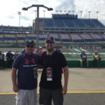 Tom Cavalli and friend standing outside on the racecar track at KY Speedway