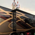 Tom Cavalli and friend standing on top of the RV